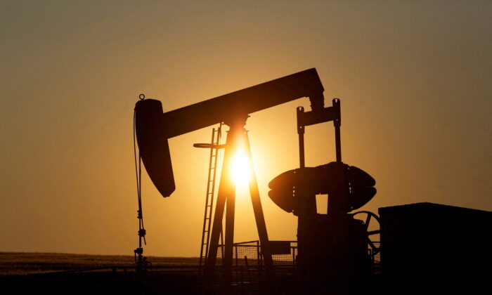 An oil pump jack pumps oil in a field near Calgary, Alberta, Canada, on July 21, 2014. (Todd Korol/Reuters)