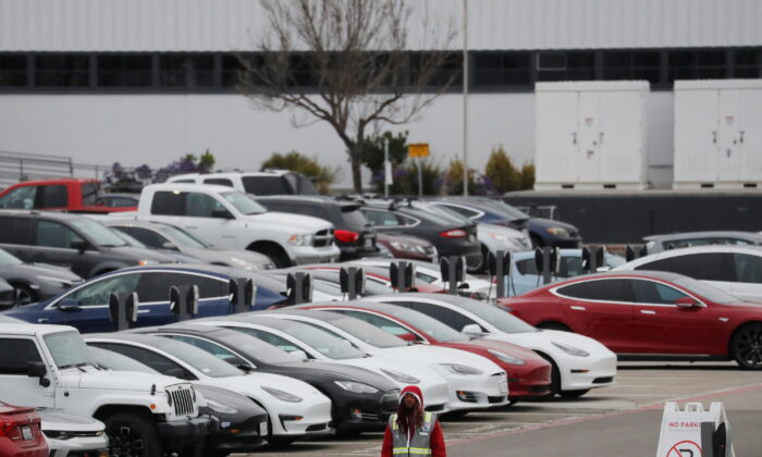 Cars are parked in the employee parking lot at Tesla Inc.'s U.S. vehicle factory in Fremont, Calif., on March 18, 2020. (Shannon Stapleton/Reuters)