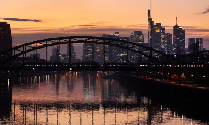 A commuter train passes by the skyline with its financial district in Frankfurt, Germany, on Oct. 25, 2021.  (Kai Pfaffenbach/Reuters)