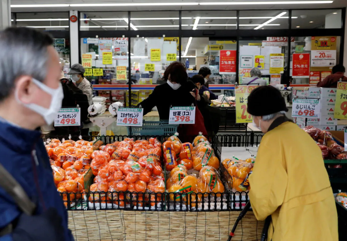 Shoppers wearing protective face masks, following an outbreak of COVID-19, at a supermarket in Tokyo on March 27, 2020. (Issei Kato/Reuters)