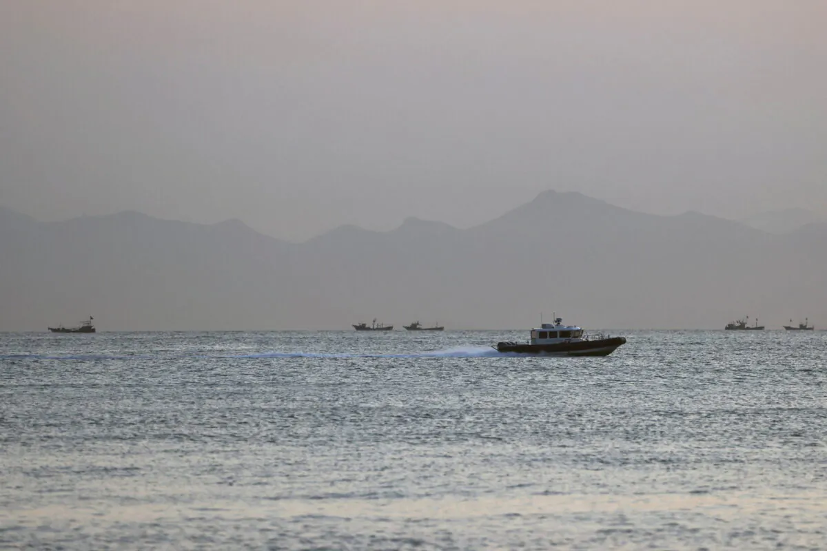 A Taiwan Coast Guard ship travels past the coast of China, in the waters off Nangan island of Matsu archipelago in Taiwan, on Aug. 16, 2022. (Ann Wang/Reuters)