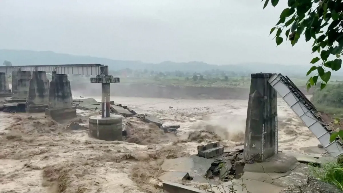 A bridge that collapsed following heavy rains in Kangra, Himachal Pradesh, India, on Aug. 20, 2022, in a screenshot from video. (ANI via Reuters) 