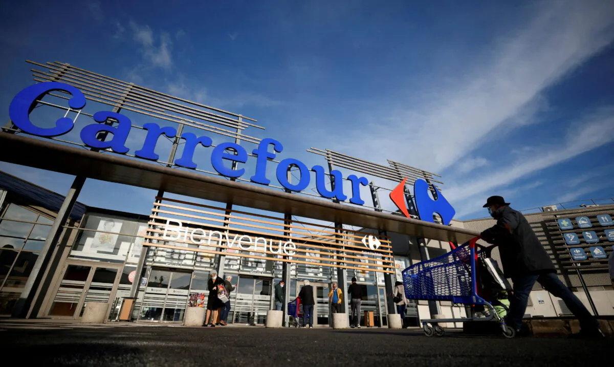 A customer pushes his shopping trolley in front of a Carrefour Hypermarket store in Saint-Herblain near Nantes, France, on Jan. 15, 2021. (Stephane Mahe/Global Business Week Ahead/Reuters)