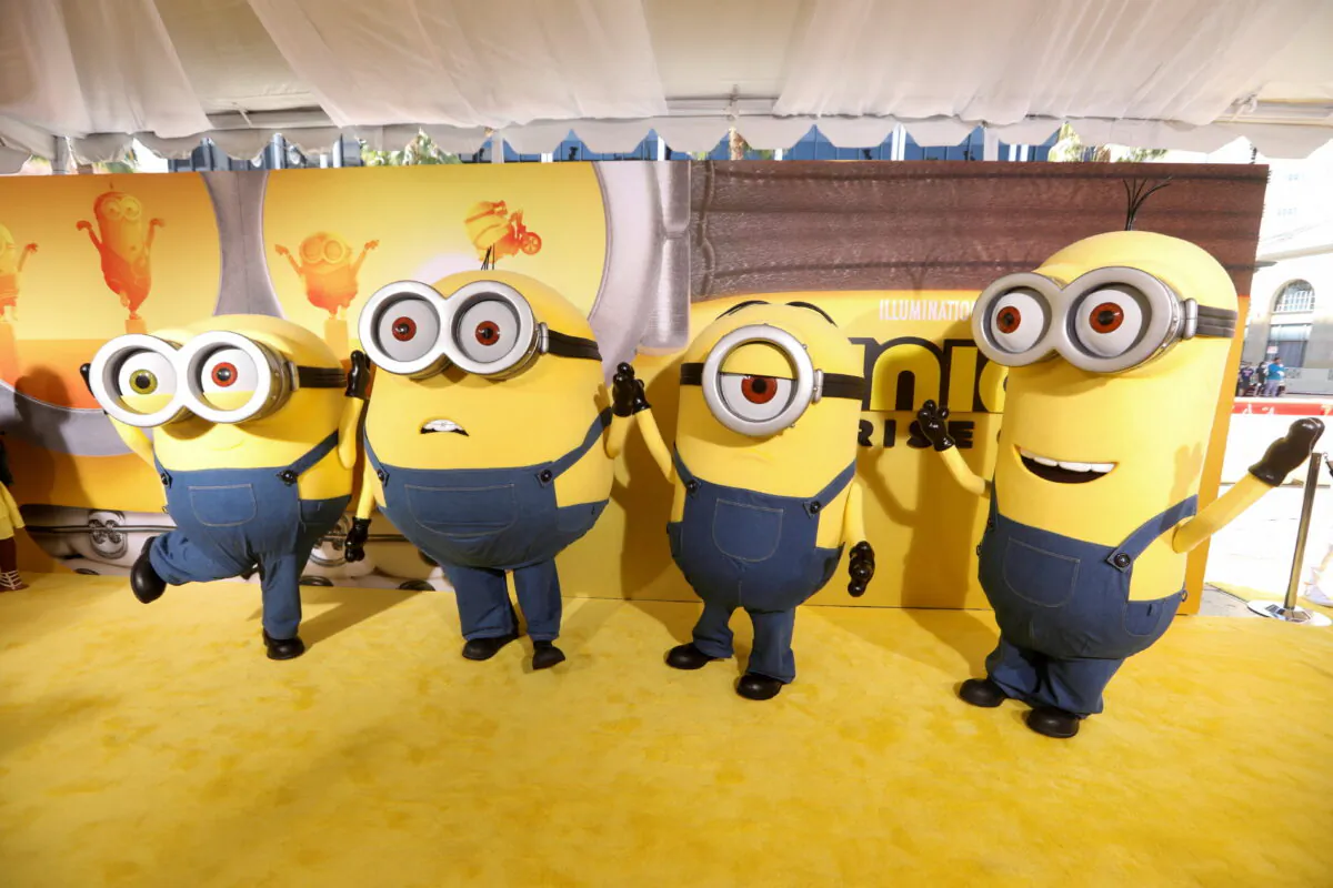 People dressed as the characters Bob, Otto, Stuart, and Kevin pose on the red carpet for "Minions: The Rise of Gru" at the TCL Chinese Theatre in Los Angeles on June 25, 2022. (David Swanson/Reuters)