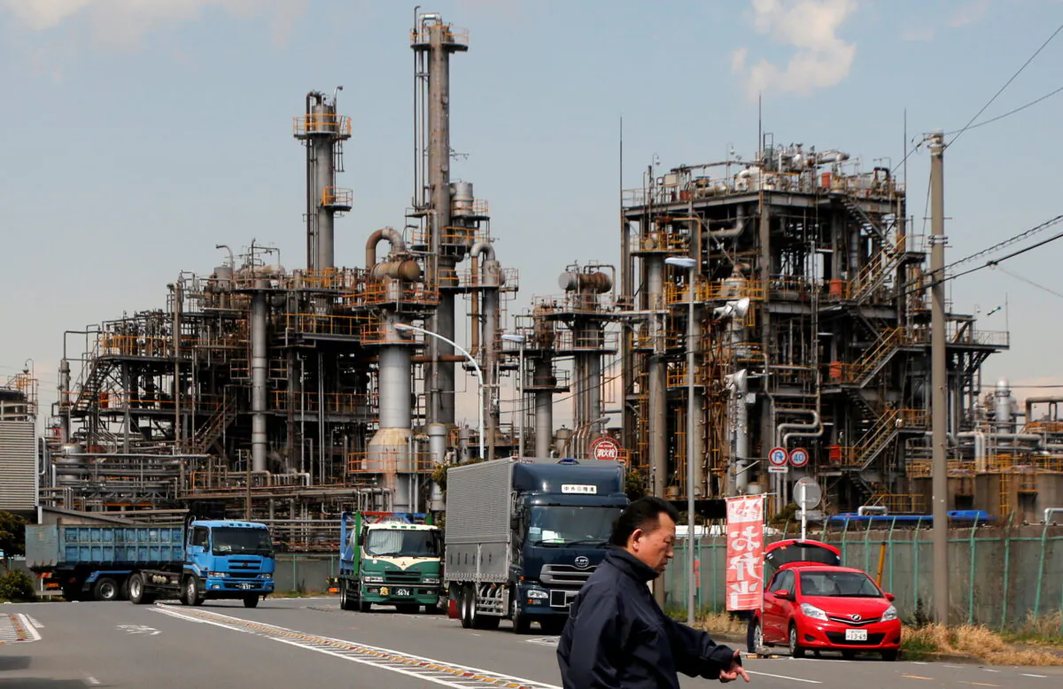 A worker walks near a factory at the Keihin industrial zone in Kawasaki, Japan, on March 8, 2017. (Toru Hanai/Reuters)
