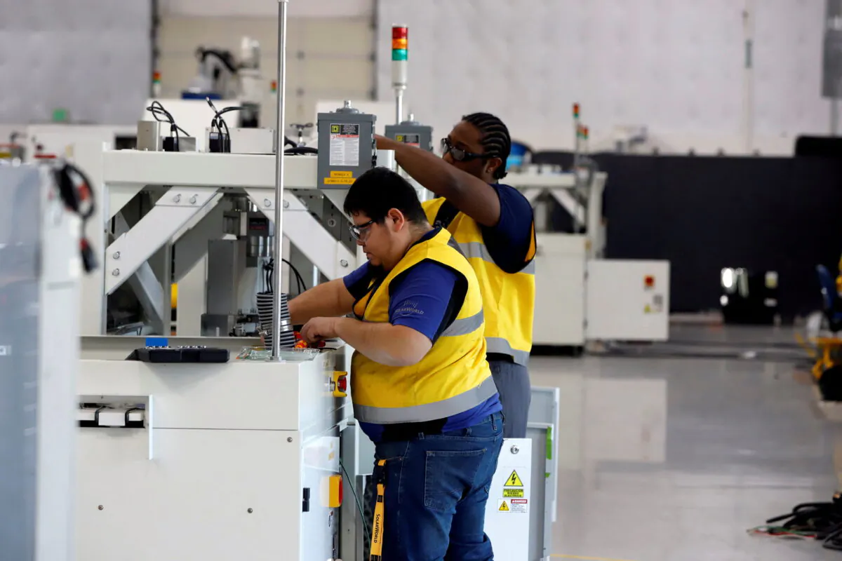 SunPower Corporation, headquartered in Silicon Valley, equipment technicians install P-Series solar panel manufacturing technology at its Hillsboro manufacturing plant in Hillsboro, Ore., on Nov. 7, 2018. (Steve Dipaola/Reuters)