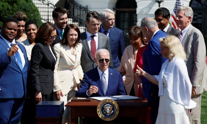 U.S. President Joe Biden signs the CHIPS and Science Act of 2022 alongside Vice President Kamala Harris, House of Representatives Speaker Nancy Pelosi, and Joshua Aviv, founder and CEO of SparkCharge, on the South Lawn of the White House in Washington, on Aug. 9, 2022. (Evelyn Hockstein/Reuters)