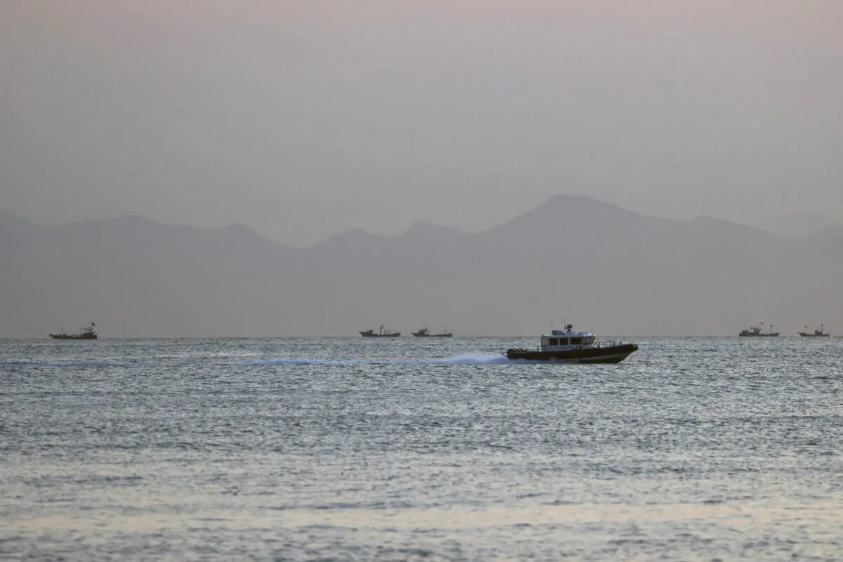 A Taiwanese coast guard ship travels past the coast of China, in the waters off Nangan Island of Matsu archipelago in Taiwan on Aug. 16, 2022. (Ann Wang /Reuters)