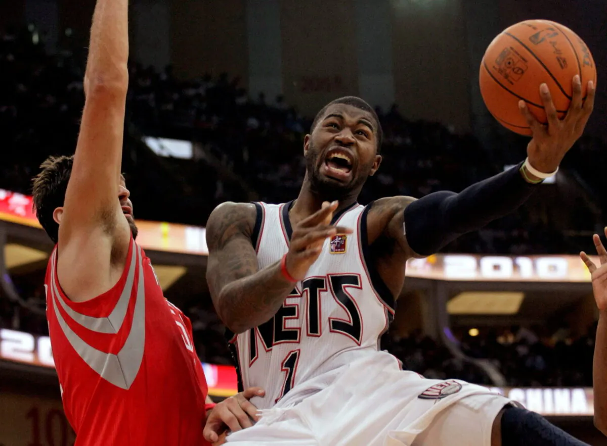 Terrence Williams (R) of the New Jersey Nets goes to the basket against Brad Miller of the Houston Rockets during the NBA China Games series at the Guangzhou International Sports Arena in Guangzhou, Guangdong province, China, on Oct. 16, 2010. (Joe Tan/Reuters)