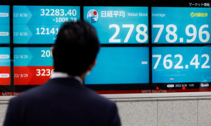 A man looks at an electronic board displaying Japan's Nikkei index outside a brokerage in Tokyo, Japan, on Aug. 29, 2022. (Kim Kyung-Hoon/Reuters)