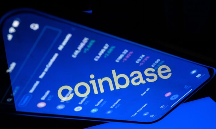 A flipped version of the Coinbase logo reflected in a mobile phone screen in London on Nov. 9, 2021, in a photo illustration. (Leon Neal/Illustration/Getty Images)