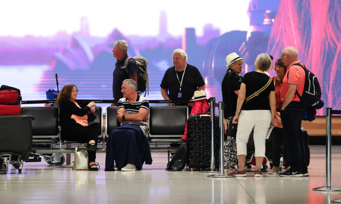 Passengers wait at the Qantas check in at Sydney International Airport in Sydney, Australia, on March 19, 2020. (Mark Metcalfe/Getty Images)