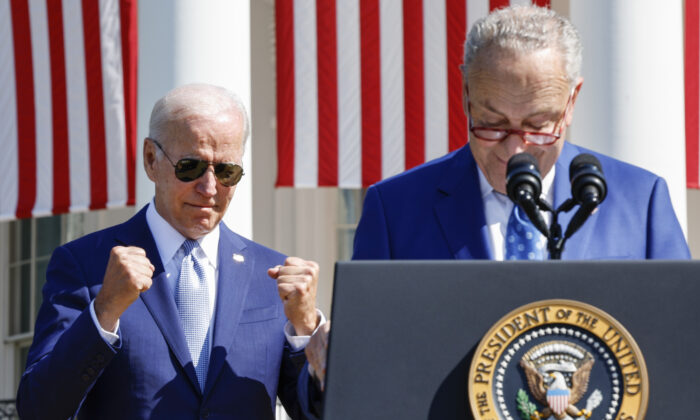President Joe Biden (L) reacts as Senate Majority Leader Chuck Schumer (D-N.Y.) speaks before Biden signs the CHIPS and Science Act of 2022 during a ceremony on the South Lawn of the White House in Washington on Aug. 9, 2022. (Chip Somodevilla/Getty Images)