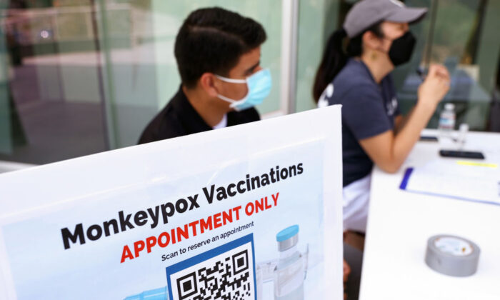Health workers sit at a check-in table at a pop-up monkeypox vaccination clinic which opened today by the Los Angeles County Department of Public Health at the West Hollywood Library in West Hollywood, Calif. on August 3, 2022 (Mario Tama/Getty Images)