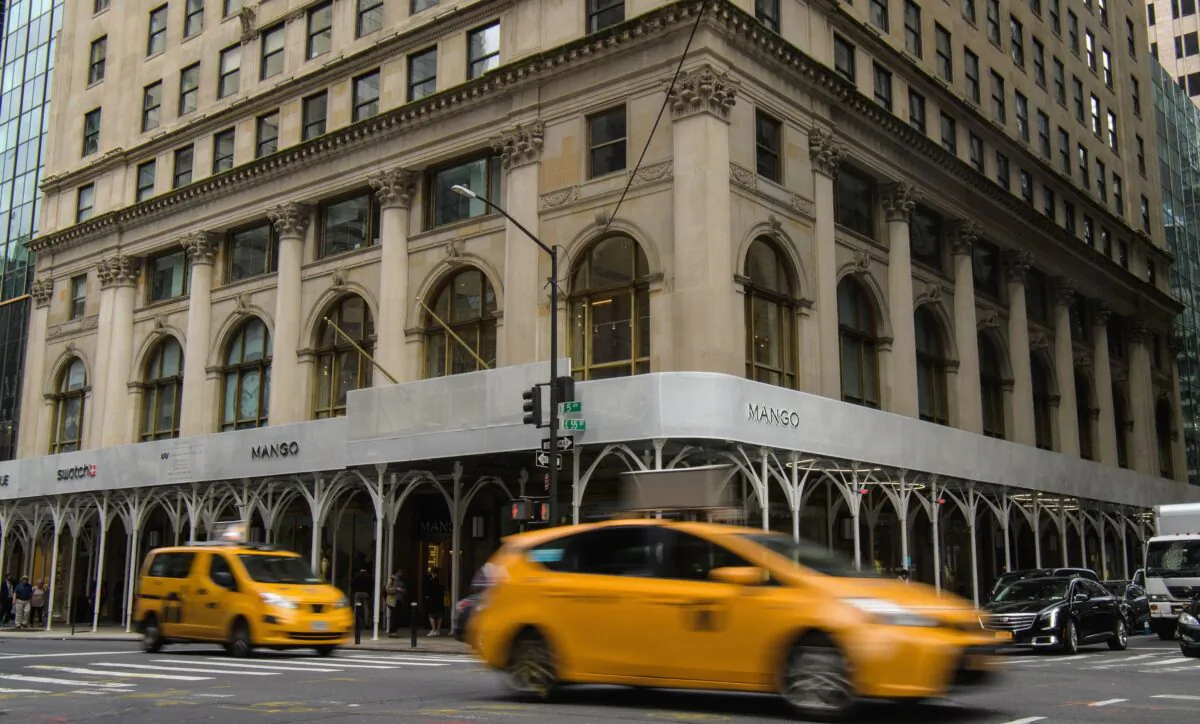 Cars drive past the newly opened flagship store for Barcelona-based clothing company Mango in New York on May 11, 2022. (Angela Weiss/AFP via Getty Images)