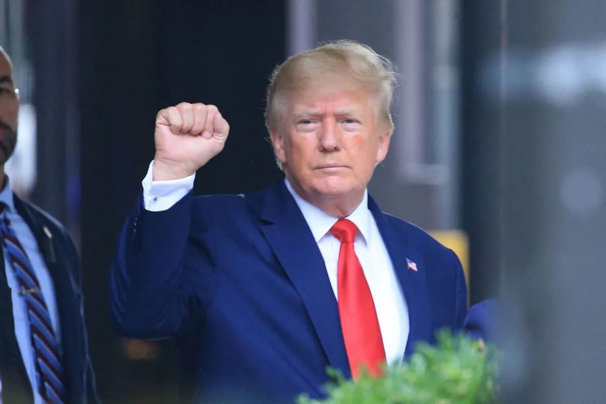 Former President Donald Trump raises his fist while walking to a vehicle outside of Trump Tower in New York on Aug. 10, 2022. (Stringer/AFP via Getty Images)