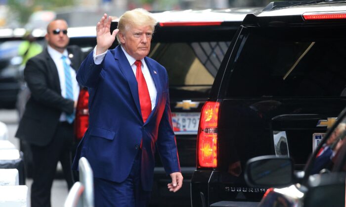 Former President Donald Trump waves while walking to a vehicle outside Trump Tower in New York on Aug. 10, 2022. (Stringer/AFP via Getty Images)