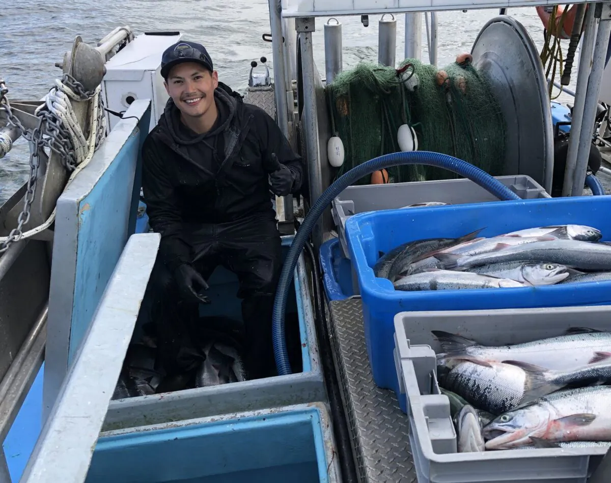 Kris Dudoward is shown aboard the commercial fishing vessel Irenda earlier this week with catch of sockeye salmon on B.C.’s Skeena River near Prince Rupert. (The Canadian Press/HO/Mitch Dudoward)