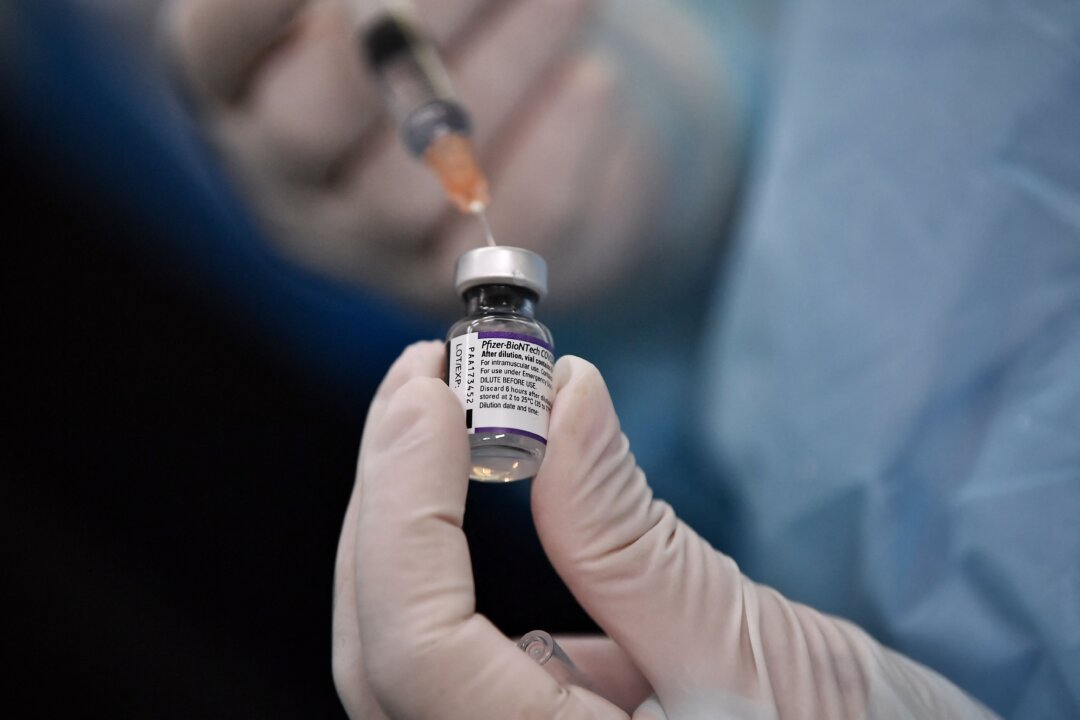 A health worker prepares a dose of the Pfizer COVID-19 vaccine at a school in Bangkok on Oct. 4, 2021. (Lillian Suwanrumpha/AFP via Getty Images)