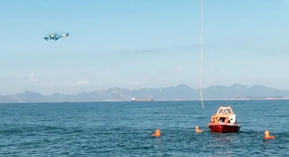 A helicopter and boat under the Eastern Theatre Command of the Chinese army take part in a maritime rescue drill, as part of military exercises in the waters around Taiwan, at an undisclosed location on Aug. 9, 2022. (Eastern Theatre Command/Handout via Reuters)