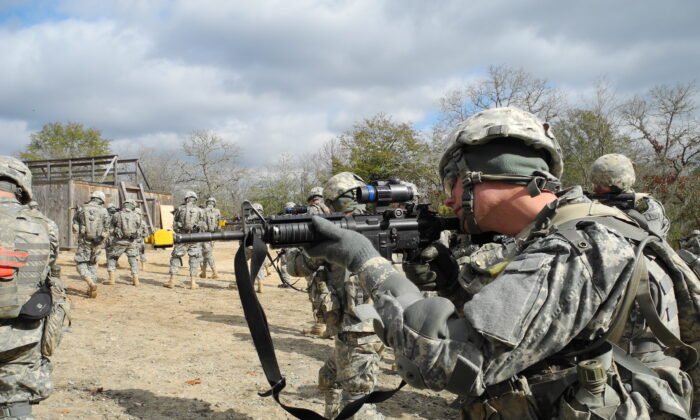 A U.S. Army recruit aims his rifle during urban warfare training at Fort Benning, Ga., on Jan. 26, 2011. (Mathieu Rabechault/AFP via Getty Images)