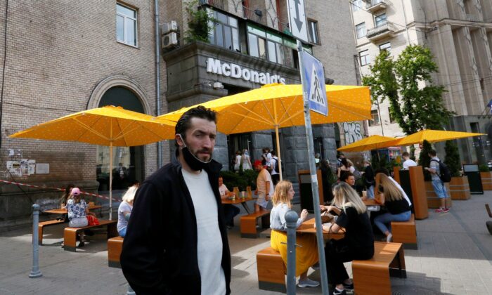 People enjoy outdoor McDonald's meal in downtown Kyiv, Ukraine, on June 9, 2020. (Efrem Lukatsky/AP Photo)