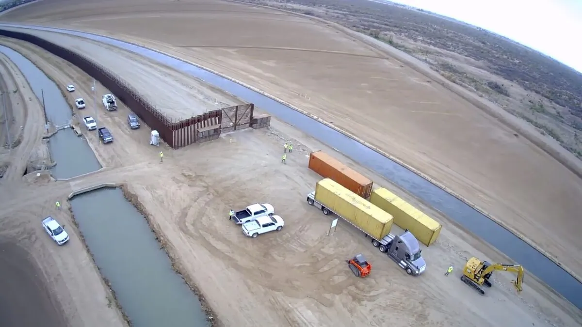 Contractors begin stacking shipping containers in border fence gaps near Yuma, Ariz., on Aug. 12, 2022. (Courtesy of Arizona Governor’s office)