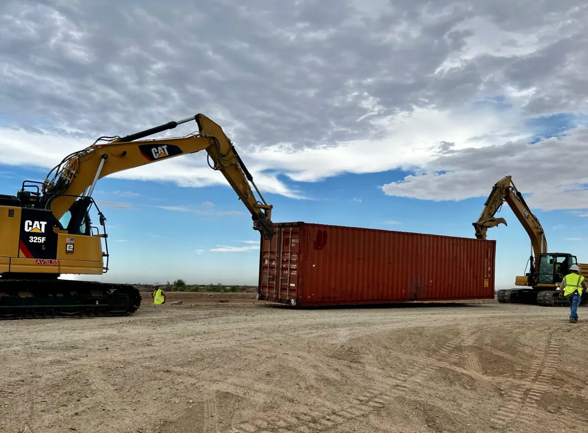 Contractors begin stacking shipping containers in border fence gaps near Yuma, Ariz., on Aug. 12, 2022. (Courtesy of Arizona Governor’s office)