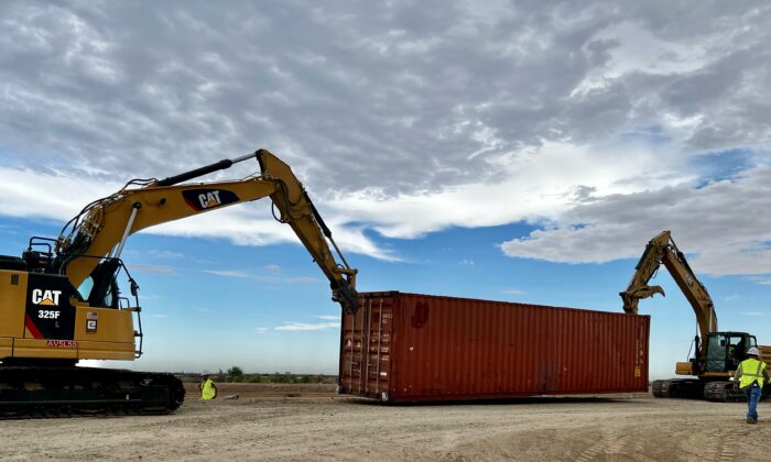 Contractors begin stacking shipping containers in border fence gaps near Yuma, Ariz., on Aug. 12, 2022. (Courtesy of Arizona Governor’s office)