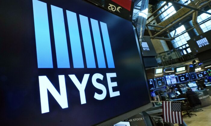 The New York Stock Exchange logo adorns a trading post on the floor of the Exchange in New York on March 16, 2022. (Richard Drew/AP Photo)