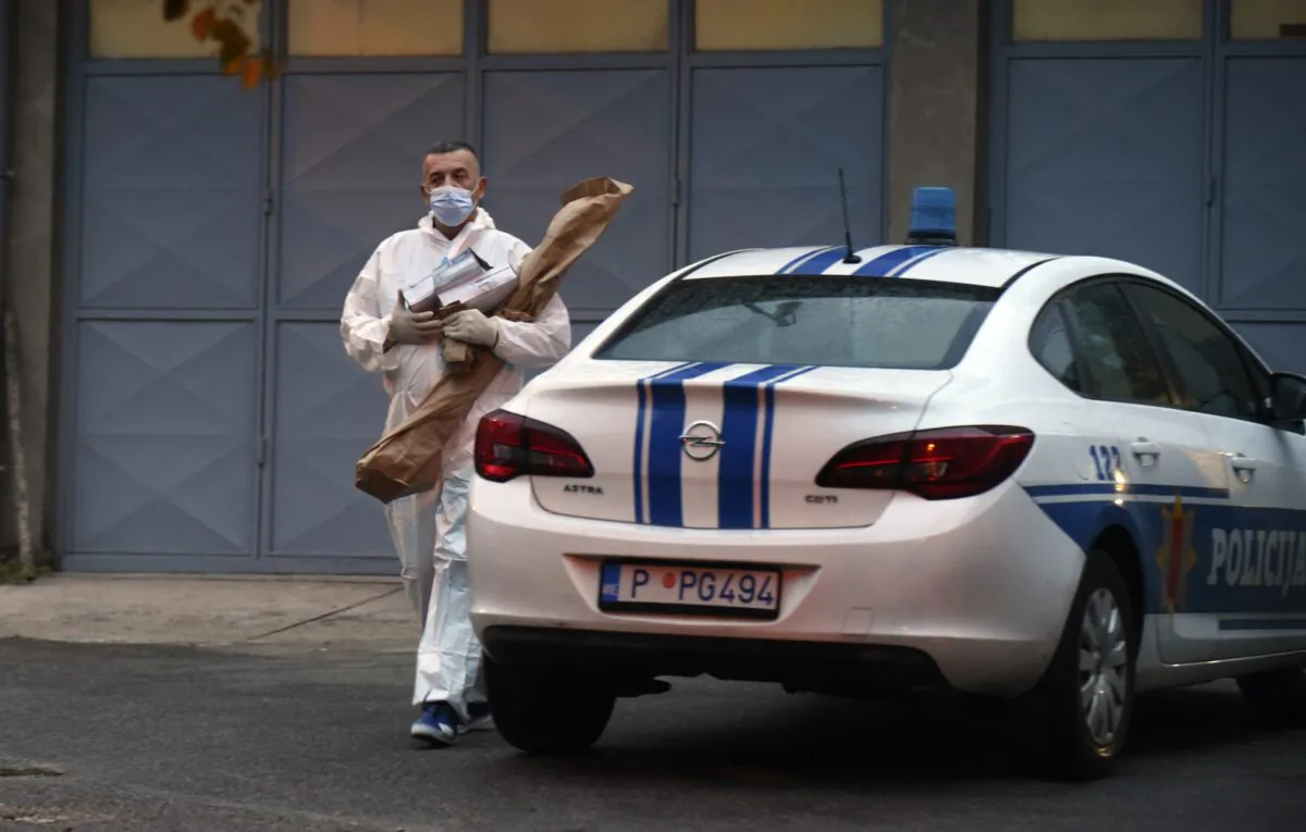 A police investigator holds evidence material on the site of the attack in Cetinje, some 30 kilometers west of Podgorica, Montenegro, on Aug. 12, 2022. (Risto Bozovic/AP Photo)