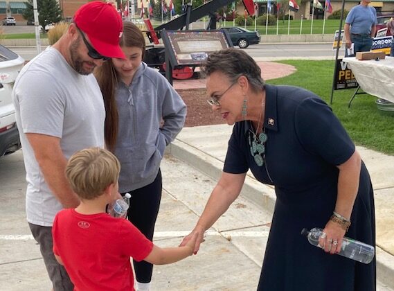 Wyoming Republican congressional candidate Harriet Hageman shakes hands will Jaymz Ackerman, 5, while his father, Lance Ackerman, and sister, Rilynn Wester, look on at a meet-and-greet in Rock Springs, Wyo., on Aug. 11. (John Haughey/The Epoch Times)