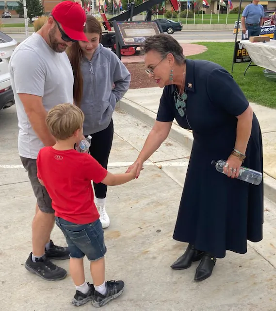 Wyoming Republican congressional candidate Harriet Hageman shakes hands will Jaymz Ackerman, 5, while his father, Lance Ackerman, and sister, Rilynn Wester, look on at a meet-and-greet in Rock Springs, Wyo., on Aug. 11. (John Haughey/The Epoch Times)