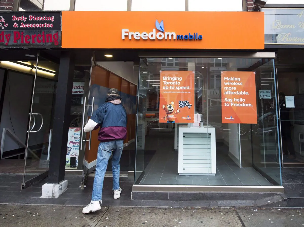 A man enters Freedom Mobile store in Toronto on Nov. 24, 2016. (The Canadian Press/Nathan Denette)