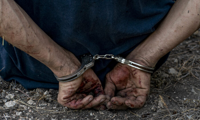 A smuggler is arrested in Kinney County, Texas, on July 29, 2022. (Charlotte Cuthbertson/The Epoch Times)