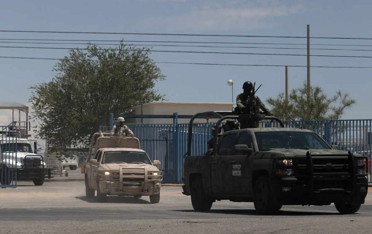 Members of the National Guard and the Mexican Army leave the airport after landing in Ciudad Juárez, Chihuahua, Mexico, on Aug. 12, 2022, after a rash of violence in the city. (Herika Martinez/AFP via Getty Images)