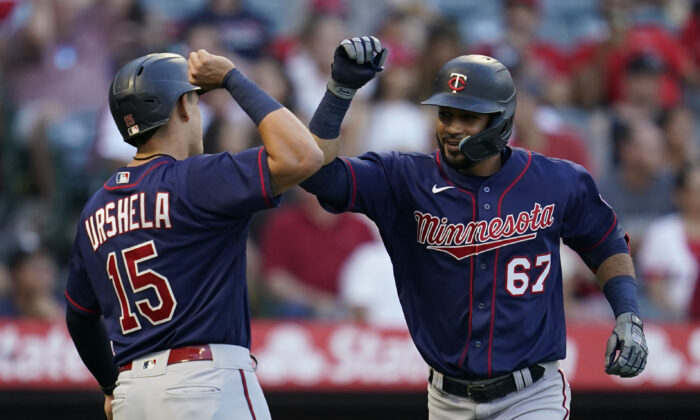 Minnesota Twins' Gilberto Celestino (67) celebrates with Gio Urshela (15) after hitting a home run during the second inning of a baseball game in Anaheim, Calif., Aug. 12, 2022. (Ashley Landis/AP Photo)