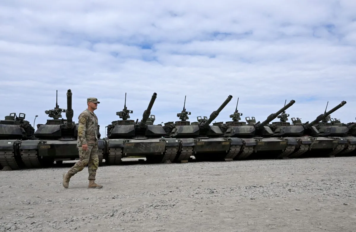 An American soldier walks in front of military tanks at the U.S. Army military training base in Grafenwoehr, southern Germany, on July 13, 2022. (Christof Stache/AFP via Getty Images)