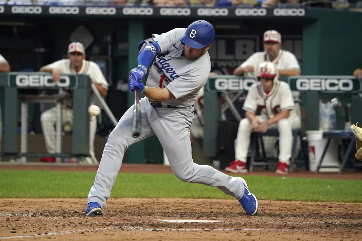 KANSAS CITY, MISSOURI - AUGUST 13: Max Muncy #13 of the Los Angeles Dodgers hits an RBI double in the sixth inning against the Kansas City Royals at Kauffman Stadium in Kansas City, on August 13, 2022. (Ed Zurga/Getty Images)