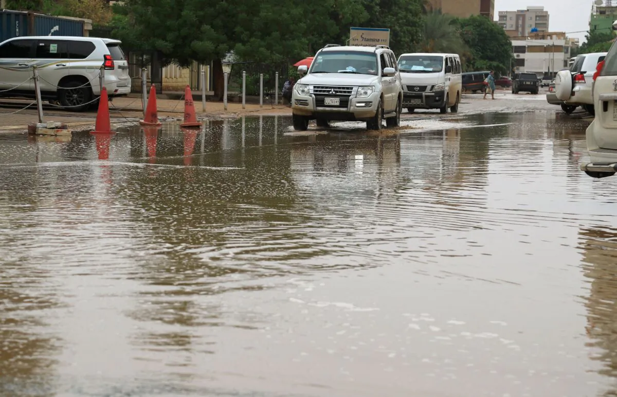 Cars drive in flood water following heavy rain in Sudan's capital Khartoum on Aug. 13, 2022. (Ashraf Shazly/AFP via Getty Images)