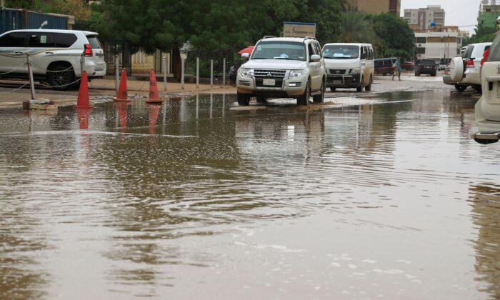 Cars drive in flood water following heavy rain in Sudan's capital Khartoum on Aug. 13, 2022. (Ashraf Shazly/AFP via Getty Images)