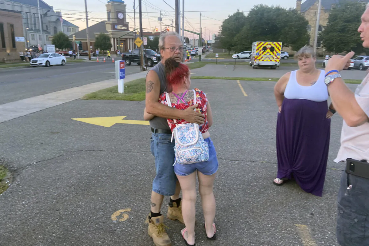 Nescopeck Volunteer Fire Company firefighter Harold Baker is comforted at the scene in Berwick, Pa., on Aug. 13, 2022, after authorities said a vehicle struck a crowd gathered at a bar to raise money for victims of a house fire that killed 10 earlier in the month. (Bob Kalinowski/The Citizens' Voice via AP)