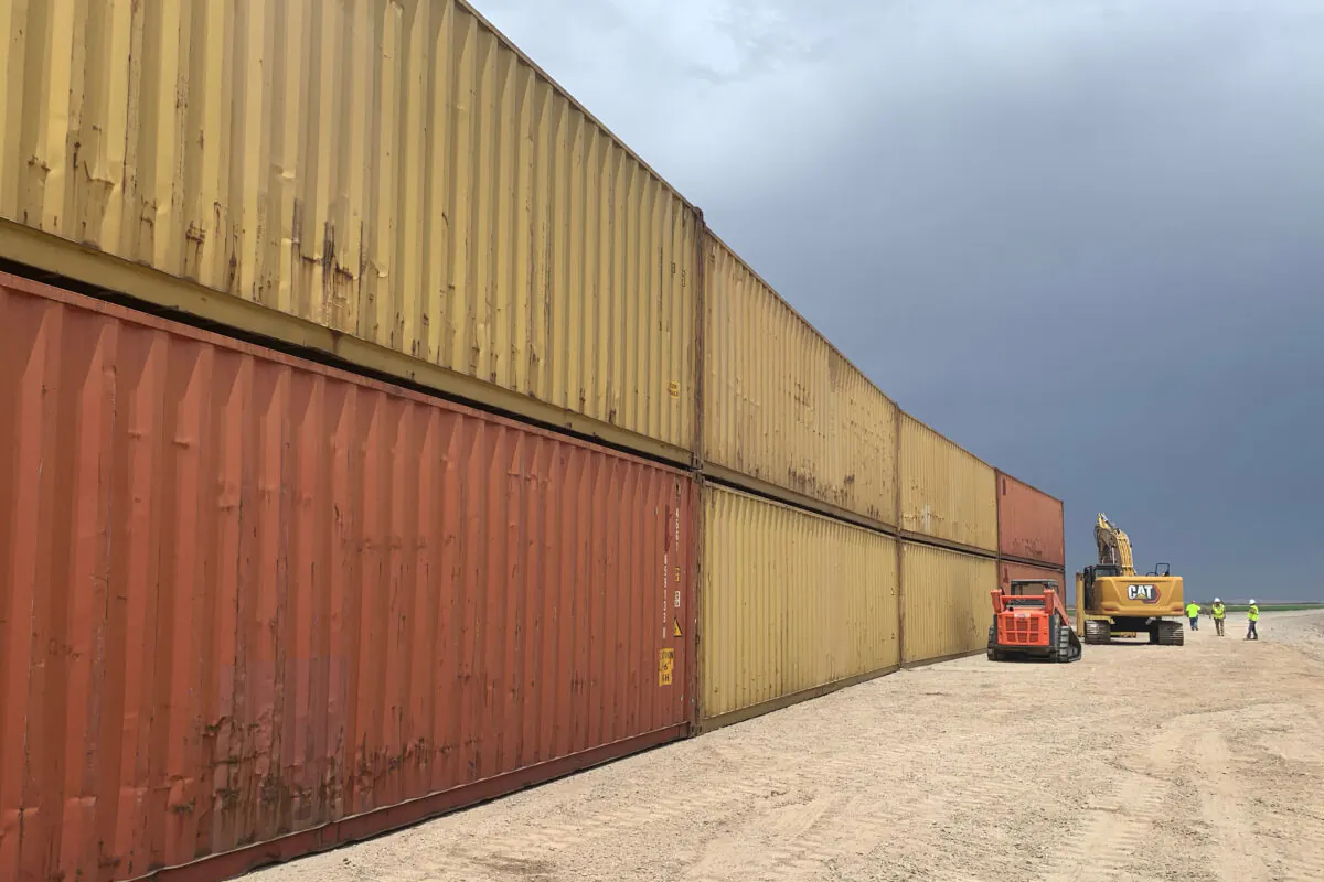 Shipping containers that will be used to fill a 1,000-foot gap in the border wall with Mexico near Yuma, Ariz., on Aug. 12, 2022. (Arizona Governor's Office via AP)