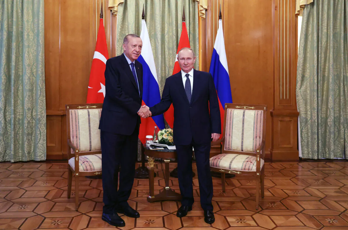 Russian President Vladimir Putin (R) shakes hands with Turkish President Recep Tayyip Erdogan during a meeting in Sochi, Russia, on Aug. 5, 2022. (Vyacheslav Prokofyev / POOL / AFP via Getty Images)