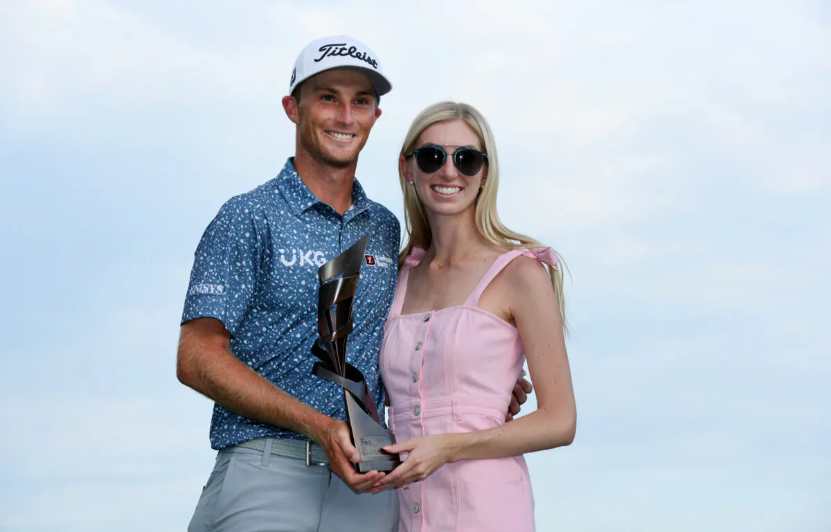 Will Zalatoris of the United States poses with the trophy and his fiance Caitlyn Sellers after putting in to win on the third playoff hole on the 11th green during the final round of the FedEx St. Jude Championship at TPC Southwind in Memphis, August 14, 2022. (Andy Lyons/Getty Images)