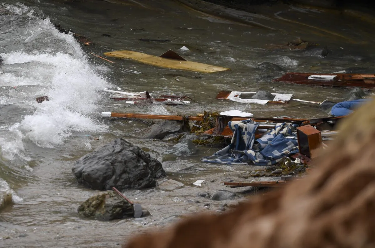 Wreckage and debris washes ashore at Cabrillo National Monument near where a boat capsized just off the coast in San Diego on May 2, 2021. (AP Photo/Denis Poroy, File)
