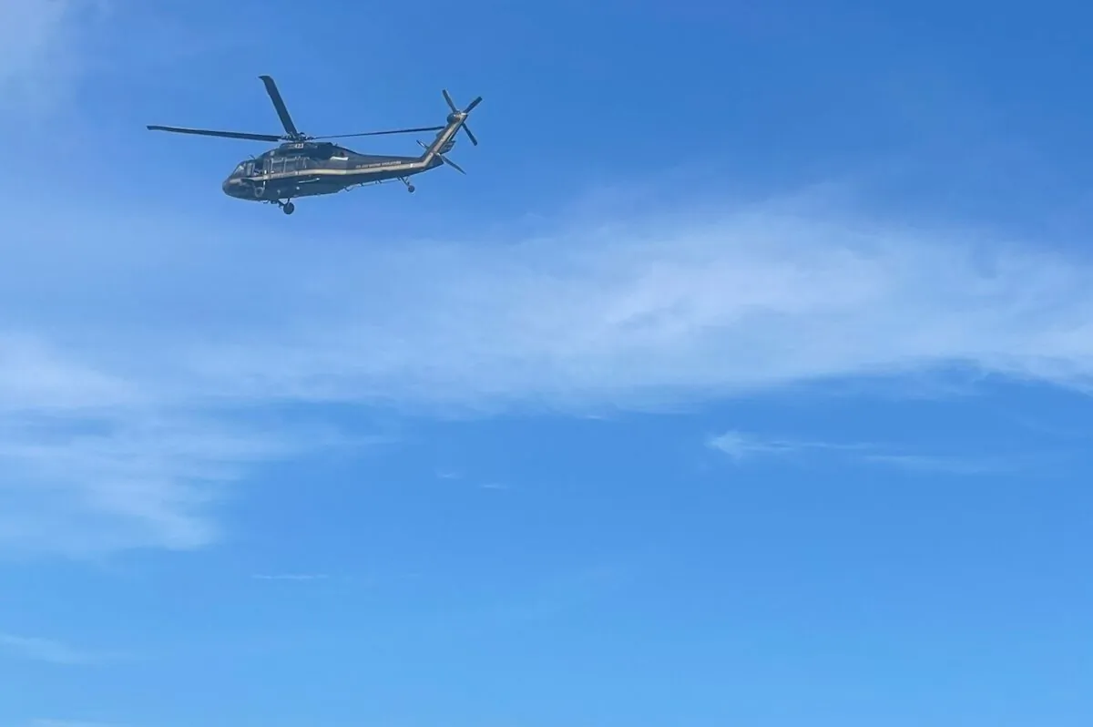 A helicopter flies off the coast of Key Largo, Fla., on Aug. 6, 2022, in this image posted on the USCGSoutheast Twitter page, near the gated community of Ocean Reef. (Courtesy of U.S. Coast Guard via AP)