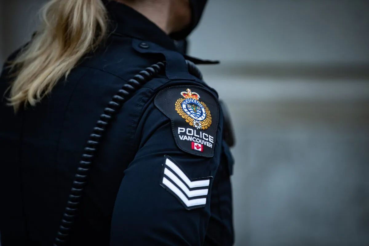 A Vancouver Police Department patch is seen on an officer's uniform as she makes a phone call after responding to an unknown incident in the Downtown Eastside of Vancouver, on Jan. 9, 2021. (The Canadian Press/Darryl Dyck)