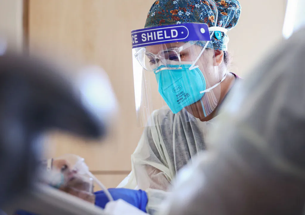 A nurse cares for a COVID-19 patient at Providence Holy Cross Medical Center in the Mission Hills neighborhood in Los Angeles, Calif., on July 30, 2021. (Mario Tama/Getty Images)