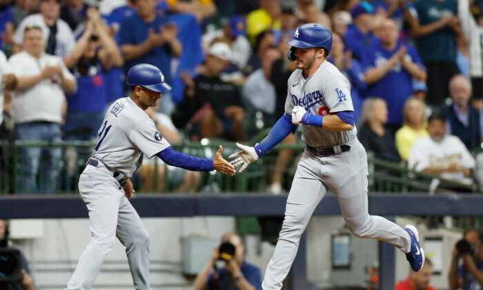 Gavin Lux #9 of the Los Angeles Dodgers celebrates his two-run home run with third base coach Dino Ebel #91 in the sixth inning against the Milwaukee Brewers at American Family Field in Milwaukee, on August 15, 2022. (John Fisher/Getty Images)